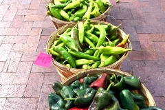 Buying local peppers and chiles at the Santa Fe Farmers Market for a catered event by Casa Nova Custom Catering, Santa Fe, NM